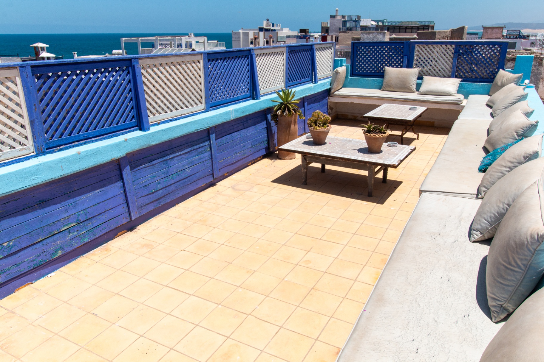 The rooftop terrace of Chill Art Hostel looking over the Essaouira medina and the Atlantic